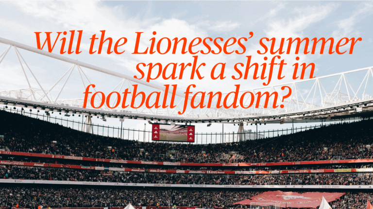 image depicts a football stadium with womens football fans awaiting a game.