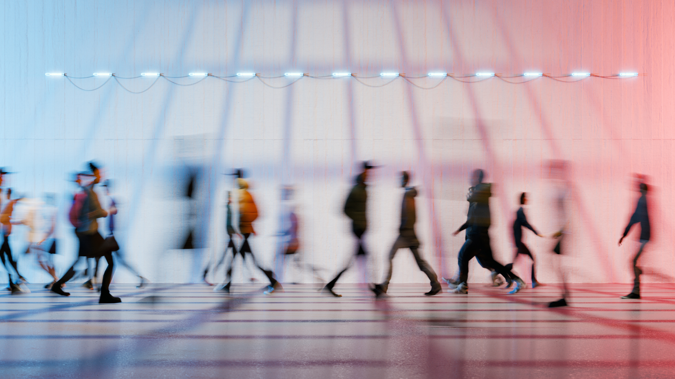 Long exposure image of people walking in a pedestrian passage