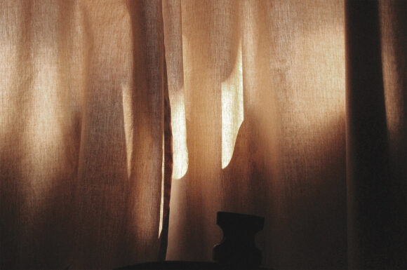image depicts abstract luxury - luxurious curtain with light shining through and creating shadows.